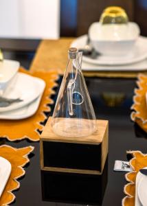 a glass siphon on a wooden box on a table at Legacy Square by QUAO REALTY in East Legon