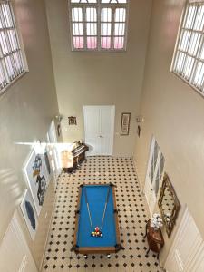 a hallway with a blue table in the middle of a room at Great House Almería in Almería