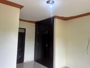 a room with a black cabinet and a ceiling at Antique Family Residence in Kitala