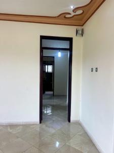 an empty hallway with an open door in a building at Antique Family Residence in Kitala
