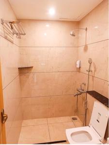 a bathroom with a toilet and a shower at tan90 Comfort Stays in Tiruchchirāppalli