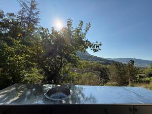 a metal bowl on top of a table with a view at Chalet d hiver in Millau