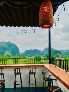 a bar with chairs and a view of mountains at Tam Coc Armany Hotel & Sky Restaurant in Vũ Lâm +63 photos