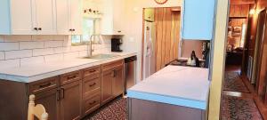 a kitchen with a sink and a counter top at Lakeview Lodge, bookable boat slip! in Bass Lake +29 photos