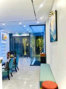 a room with chairs and a table in a building at Tam Coc Armany Hotel & Sky Restaurant in Vũ Lâm