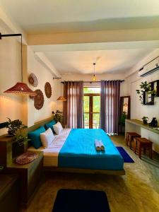 a bedroom with a large blue bed in a room at Little J villa in Dickwella