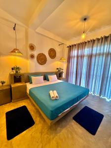 a bedroom with a large bed with two pillows on it at Little J villa in Dickwella
