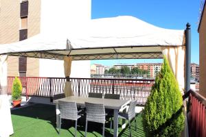 a table and chairs under a canopy on a balcony at Hotel Terminal in Milan