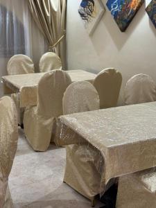 a group of tables and chairs covered in plastic at فندق ضيف العزيزية in Ajyad