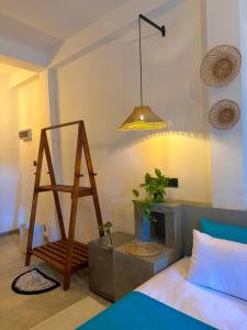 a room with a bed and a ladder and a lamp at Little J villa in Dickwella