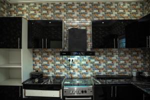 KartungにあるHomeのキッチン(黒いキャビネット、コンロ付)
