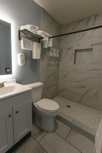 a bathroom with a white toilet and a sink at Hillsboro Inn & Suites in Hillsboro