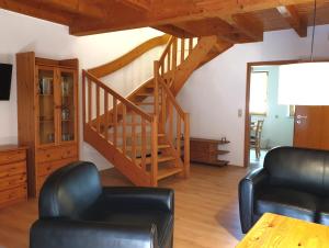 a living room with a spiral staircase in a house at Natur Ferienpark 8 - Typ A in Nieheim