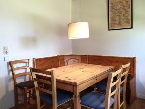 a dining room table with four chairs and a lamp at Natur Ferienpark 8 - Typ A in Nieheim