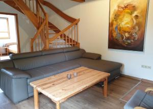 a living room with a couch and a coffee table at Haus 10 Die Kulisse Teutoburger Wald hautnah erleben in Natur Ferienpark in Nieheim