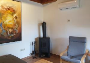 a living room with a chair and a stove at Haus 10 Die Kulisse Teutoburger Wald hautnah erleben in Natur Ferienpark in Nieheim