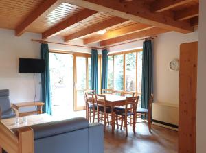 a living room with a table and chairs at Natur Ferienpark 10 - Typ C in Nieheim