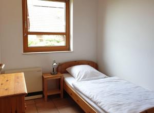 a small bedroom with a bed and a window at Natur Ferienpark 10 - Typ C in Nieheim +7 photos