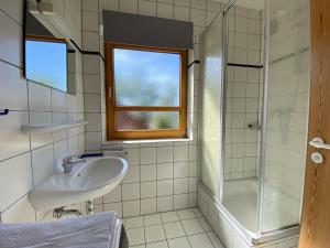a bathroom with a sink and a shower at Haus 10 Die Kulisse Teutoburger Wald hautnah erleben in Natur Ferienpark in Nieheim +16 photos