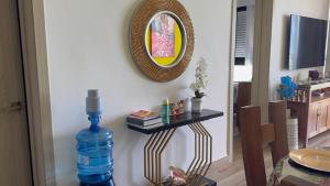 a room with a bottle of water and a mirror at Paradise Apt in Punta Cana in Punta Cana