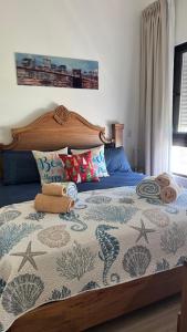 a bedroom with a bed with a wooden head board at Paradise Apt in Punta Cana in Punta Cana
