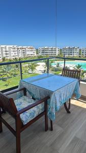 a ping pong table and two chairs on a balcony at Paradise Apt in Punta Cana in Punta Cana