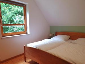 a bedroom with a bed and a window at Natur Ferienpark 9 - Typ C in Nieheim
