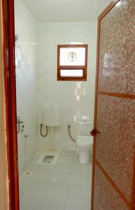 a bathroom with a toilet and a window at Al Hudu Mountain House - Jebel Shams in Al Ḩayl