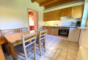 a kitchen with a wooden table and chairs at Natur Ferienpark 25 - Typ A in Nieheim