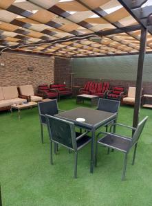a patio with a table and chairs in a room at Marina Privet chalet for rent in Al Jafr