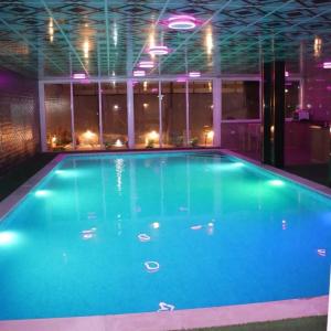 a large swimming pool in a building at Marina Privet chalet for rent in Al Jafr
