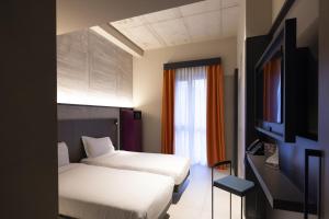 TV a/nebo společenská místnost v ubytování Joy 124 Hotel Milano