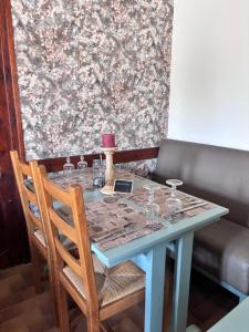 a blue table with glasses on top of it at Auberge Les Bastides 