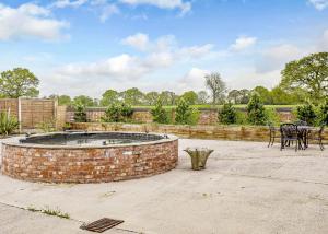 a brick fountain in a patio with tables and chairs at Ladera Retreat Lodges in Eaton