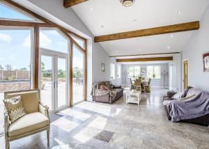 an open living room with large windows and couches at Ladera Retreat Lodges in Eaton