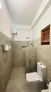 a bathroom with a toilet and a sink at Royal Sea Wind in Matara