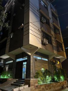a building with a clock tower at night at Karachi Inn PECHS in Karachi