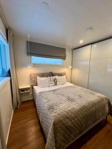 a bedroom with a large bed and a window at Arctic Circle Guesthouse in Rovaniemi