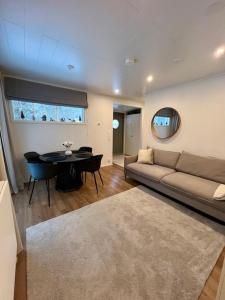 a living room with a couch and a table at Arctic Circle Guesthouse in Rovaniemi