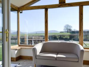 a white couch in a room with windows at Upper Close - Uk10873 in Evenjobb