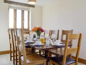 a dining room with a wooden table and chairs at Upper Close - Uk10873 in Evenjobb