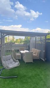 a patio with chairs and a table on a balcony at Vila in Chişinău