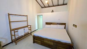 a bedroom with a bed and a ladder in it at Canmin Guest House in Galle