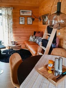 a living room with a couch and a table at Charming Small Cabin At The Top Of Blefjell in Flesberg