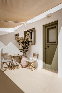 a patio with a table and chairs and a door at Kisari Kimolos Chorio Double Room in Kimolos