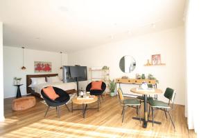 a bedroom with a bed and two tables and chairs at וילה מעגל השמש in Poriyya Illit