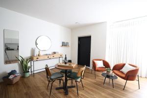 a living room with a table and chairs and a mirror at וילה מעגל השמש in Poriyya Illit +15 photos