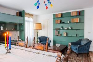 a living room with a fireplace and two chairs and a candle at Ca' Magno by Venicevillas, dimora storica in Venice