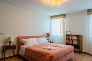 a bedroom with a bed with two towels on it at Ca' Magno by Venicevillas, dimora storica in Venice