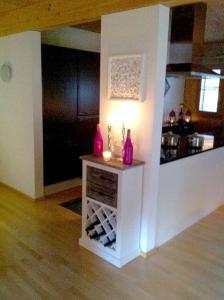 a room with a table with wine bottles and a light at Chalet Auszeit Montafon in Bartholomäberg